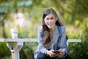 Business woman using tablet on lunch break in city park