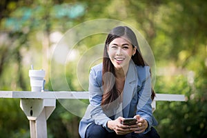 Business woman using tablet on lunch break in city park