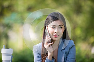 Business woman using tablet on lunch break in city park