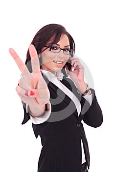 Business woman victory sign & phone