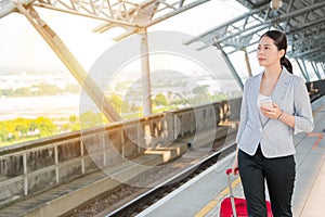 Business woman walking on the rail platform