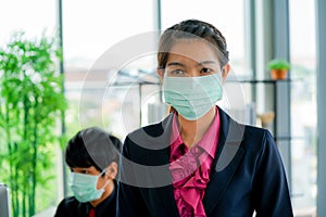 Business woman was sick from flu in the office and the male enployee offer the protecitve face mask sfety fro COVID-19 virus