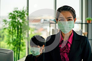 Business woman was sick from flu in the office and the male enployee offer the protecitve face mask sfety fro COVID-19 virus