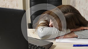 Business woman was weakened at work and fell asleep at a computer. close-up. tired office worker sleeps on documents at