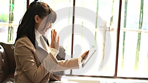 Business woman waving hand for greeting with video conference.