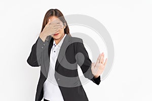 business woman wearing black suit closing eyes with rejection hand gesture