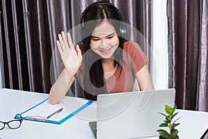 Business woman wearing headphones video call conference