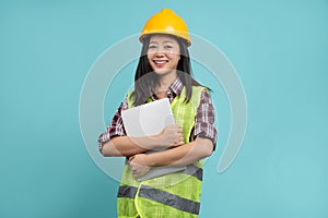 Business woman wearing safety hat and holding laptop