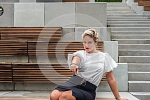 Business woman in white blouse black skirt, pointing at you