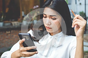 Business woman in white shirt working in cafe