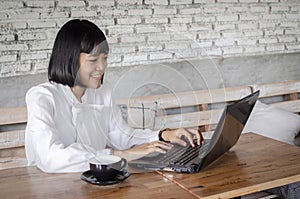 Business woman in white shirt working in cafe