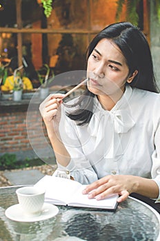 Business woman in white shirt working in cafe