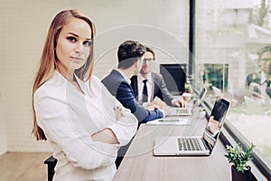 Business woman working with business team by laptop computer. Beauty and Technology concept. Smart lady and working woman theme.