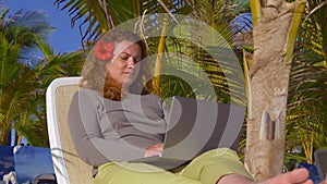 Business woman working with computer on the beach. Freelance concept.