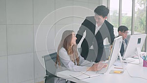 Business woman working with computer and having problem, friend man assistance and consulting about solving trouble technical.