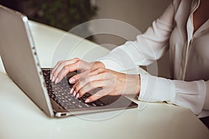 Business woman working with computer in office. Side view of female hands typing keyboard. Close up shot. High quality