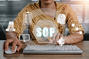 Business woman working on computer with SOP icon on virtual screen