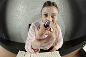 Business woman is working on the computer, threatens with finger