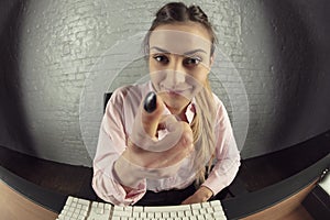 Business woman is working on the computer, threatens with finger