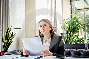 Business woman working with documents at cafe