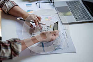 Business woman working in finance and accounting Analyze financial budget in the office.