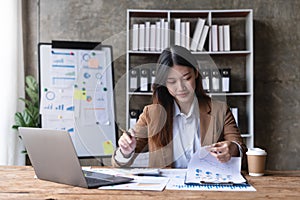 Business woman working in finance and accounting Analyze financial budget in the office
