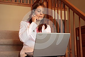 Business woman working at home on her laptop