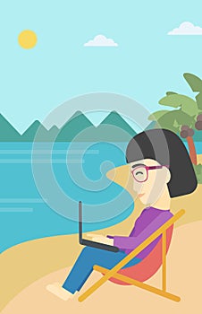 Business woman working on laptop on the beach.