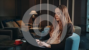 Business woman working laptop computer in hotel lobby. Woman using notebook