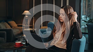 Business woman working laptop computer in hotel lobby. Woman using notebook