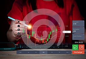 Business woman working on laptop computer, stock market graph, business concept.