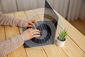 Business woman working at laptop. Hands of a female freelancer