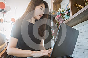 Business woman working on laptop and looking at screen in home o