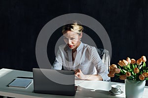 Business woman working on laptop in office online