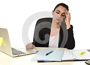 Business woman working on laptop at office in stress suffering intense headache migraine