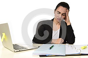 Business woman working on laptop at office in stress suffering intense headache migraine