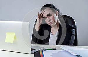 Business woman working on laptop at office in stress suffering intense headache migraine