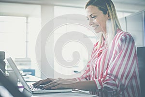 Business woman working in office. Business woman typing on laptop.