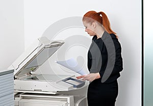 Business woman working on office printer photo