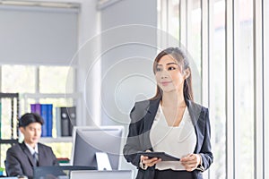 Business woman working at the office, Smiling young woman with tablet, Two young business colleagues in modern office