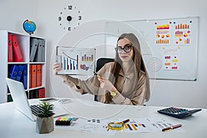 Business woman working at office with statistics and analytic research documents