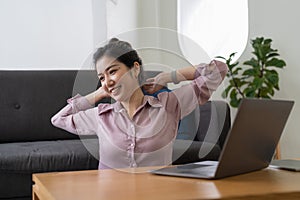 A business woman working in an office stretches to relax from work during breaks at home