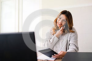 Business Woman working at the Office taking phone call