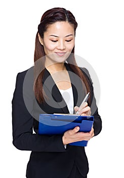 Business woman write something on file pad