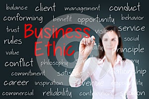 Business woman writing business ethic concept. Blue background. photo