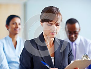 Business woman, writing and clipboard in meeting, presentation or corporate workshop at office. Female person or
