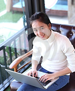 Business woman writing on clipboard outside on terrace.