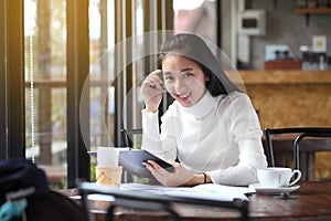 Business woman writing on clipboard outside on terrace.