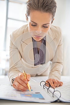 Business woman writing in document