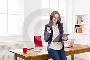 Business woman writing down notes at office